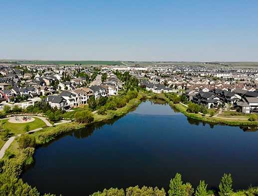 A picture of the massive pond and walkways in Cooper's Crossing Airdrie Alberta